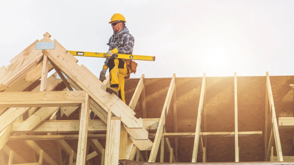Najczęstsze błędy podczas budowy dachu - zdjęcie przedstawia specjalistę stojącego na perfekcyjnie zbudowanycm dachu